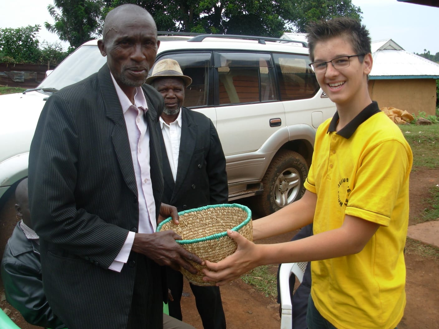 Pastor Machuka gifting brother Caleb with traditional Kisii plate when Caleb was about to leave for Canada in 2016